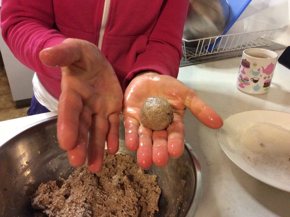 With wet hands (so the mixture doesn't stick to you) take a chunk of the mixture, roll it into a ball, then coat with desiccated coconut. Refrigerate until firm for about an hour.