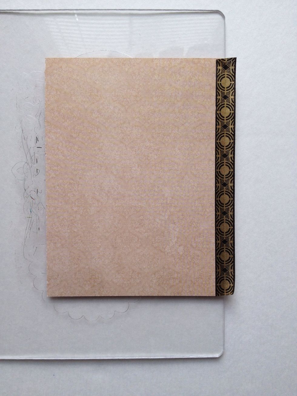 With your 4.5" wide piece of paper flipped over, attach a strip of washi tape along the right side, but attach only half of the material so that the other half of washi tape is exposed.