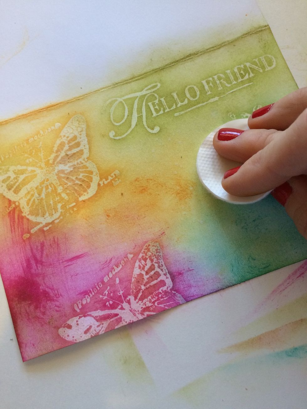 With your clean cotton pad, lightly wipe over your card. Use a gentle touch...the damp cardstock can be sensitive. Pay close attention to your stamped images to remove the ink from it.