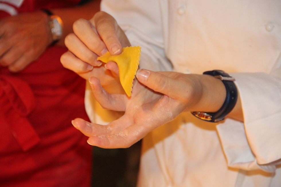 With your finger in the center of the square fold over like here