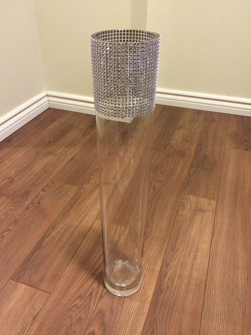 With your glue in place, carefully place your trim on the vase. Make sure the ends meet so that the seam looks flawless.