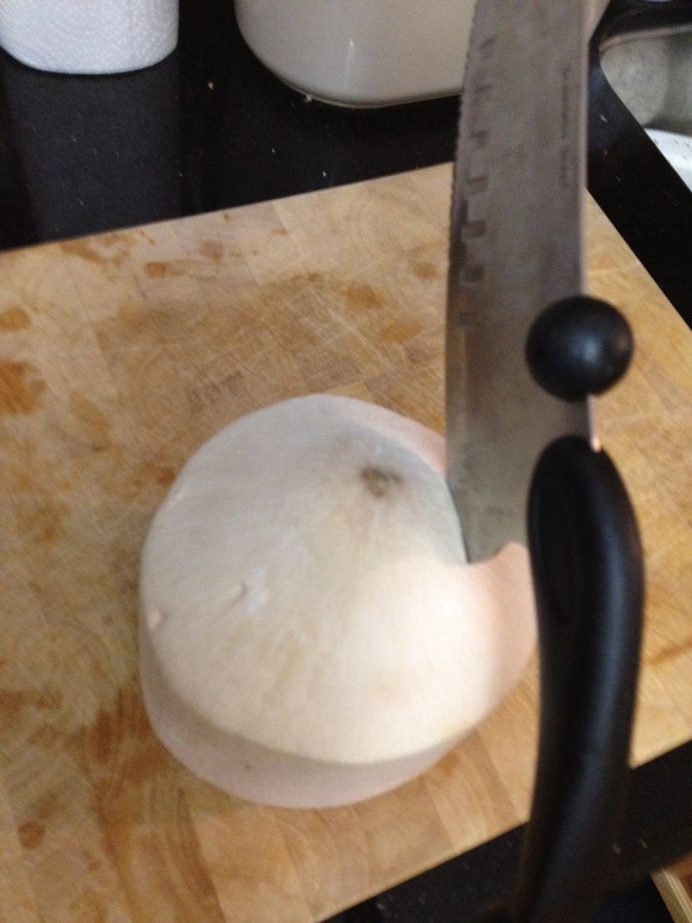 With your hands far away from your coconut, drive the inside sharpe edge of your knife into the 4 corners 2 inches from the centre www.PowerofFood.com