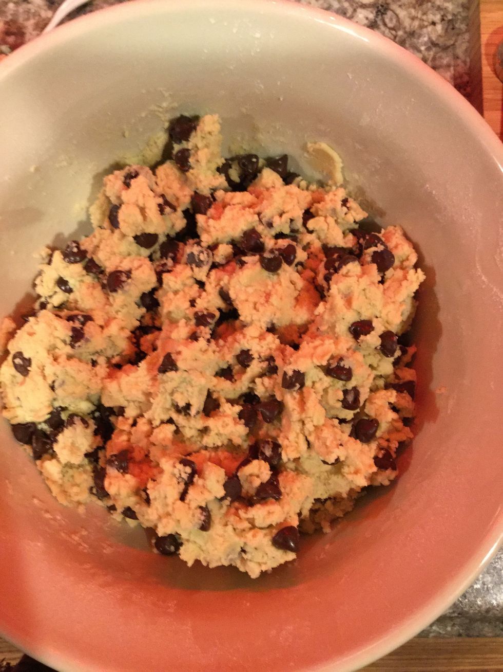 With your hands mix the cookie dough and the chocolate chips together.