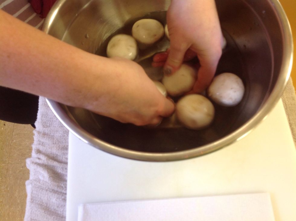 With your hands quickly rub the mushrooms to get all the dirt off.