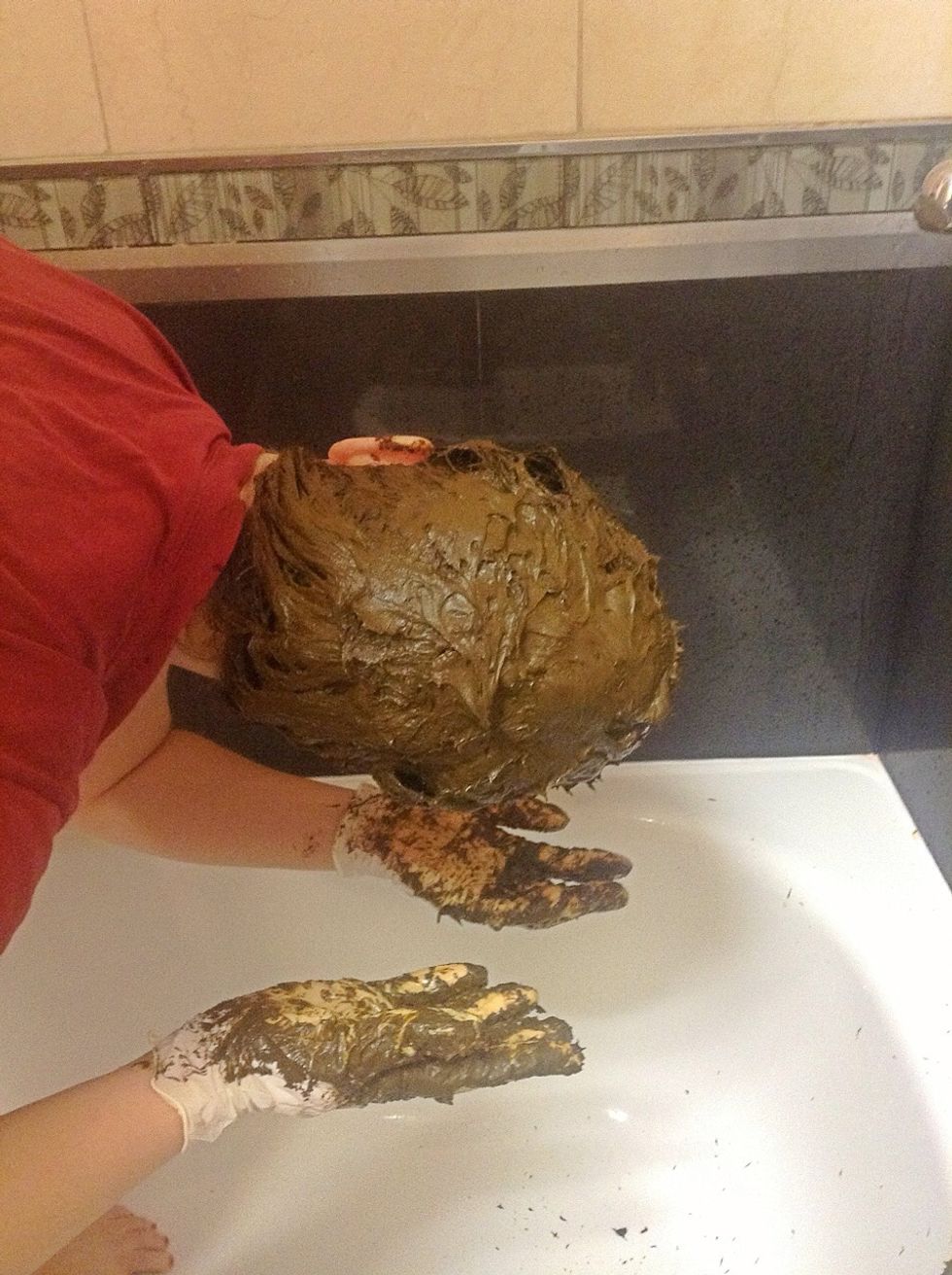 With your head upside down, paste the mix from neckline to forehead, layer by layer coating from roots to tips, moulding the hair into a pile on top of your head as you go. Messy but fun!