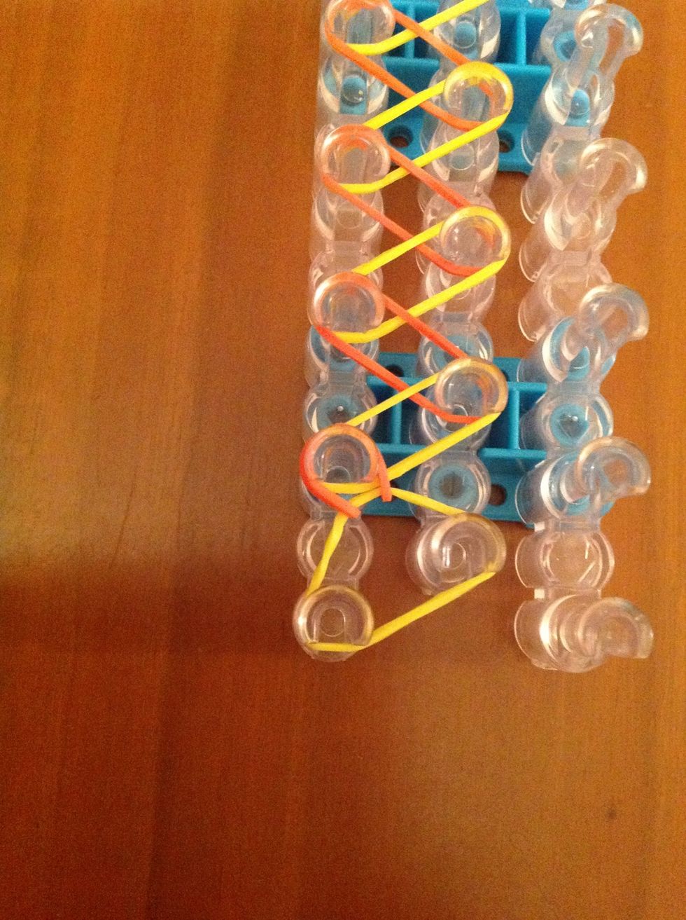 With your hook, take hold of the second rubber band. Take it off the spoke and put it on the spoke with the same rubber band on it.