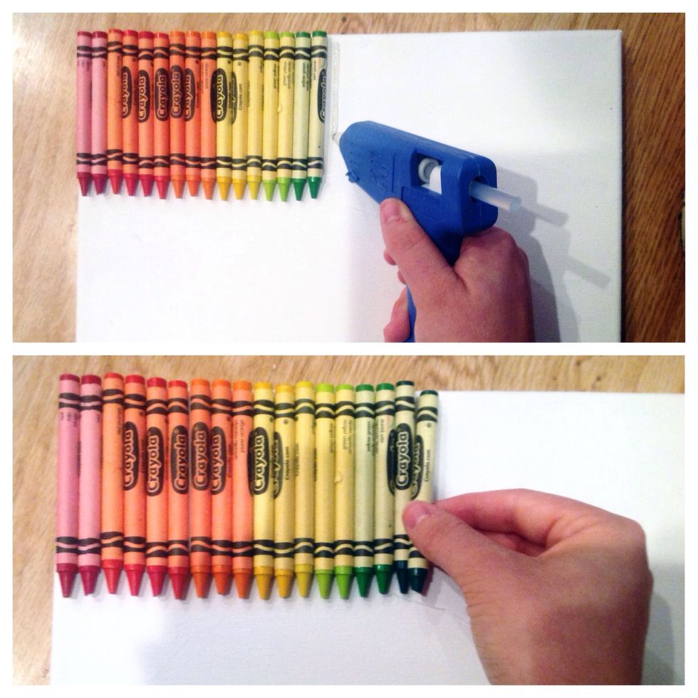 With your hot glue gun, carefully glue each crayon to the canvas. Put the crayons close together when gluing for a better end result.