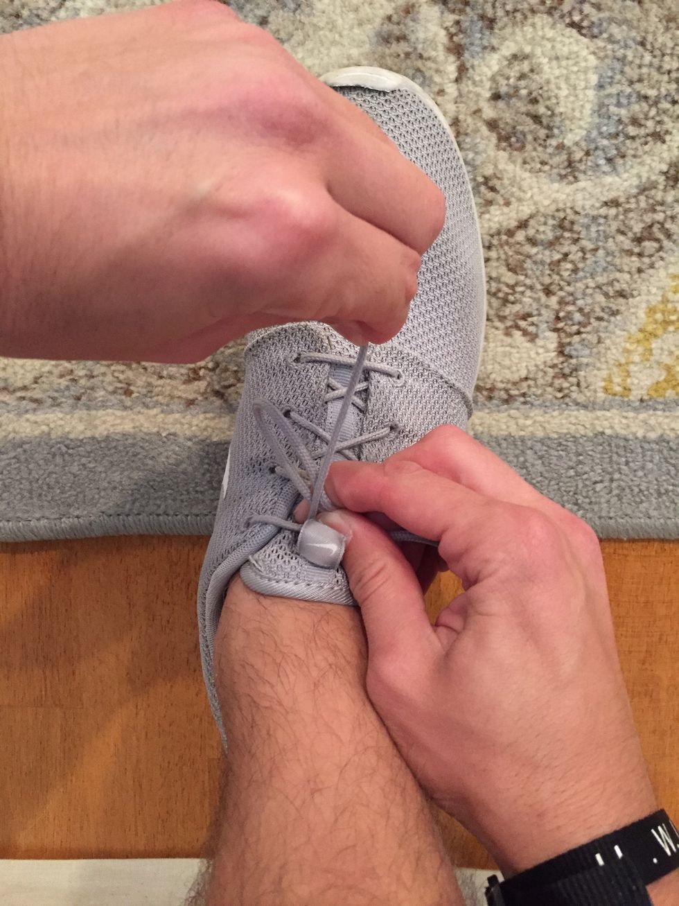 With your left hand, wrap the lace over the pinched "loop"