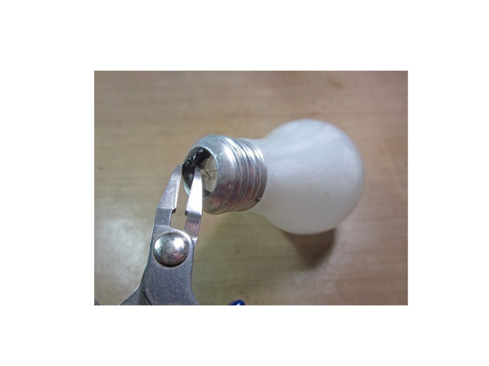 With your pliers break out the dark glass plug in the bottom of the blub. I then took a screwdriver and very carefully broke the glass tube in the center and cleared all the excess glass out.