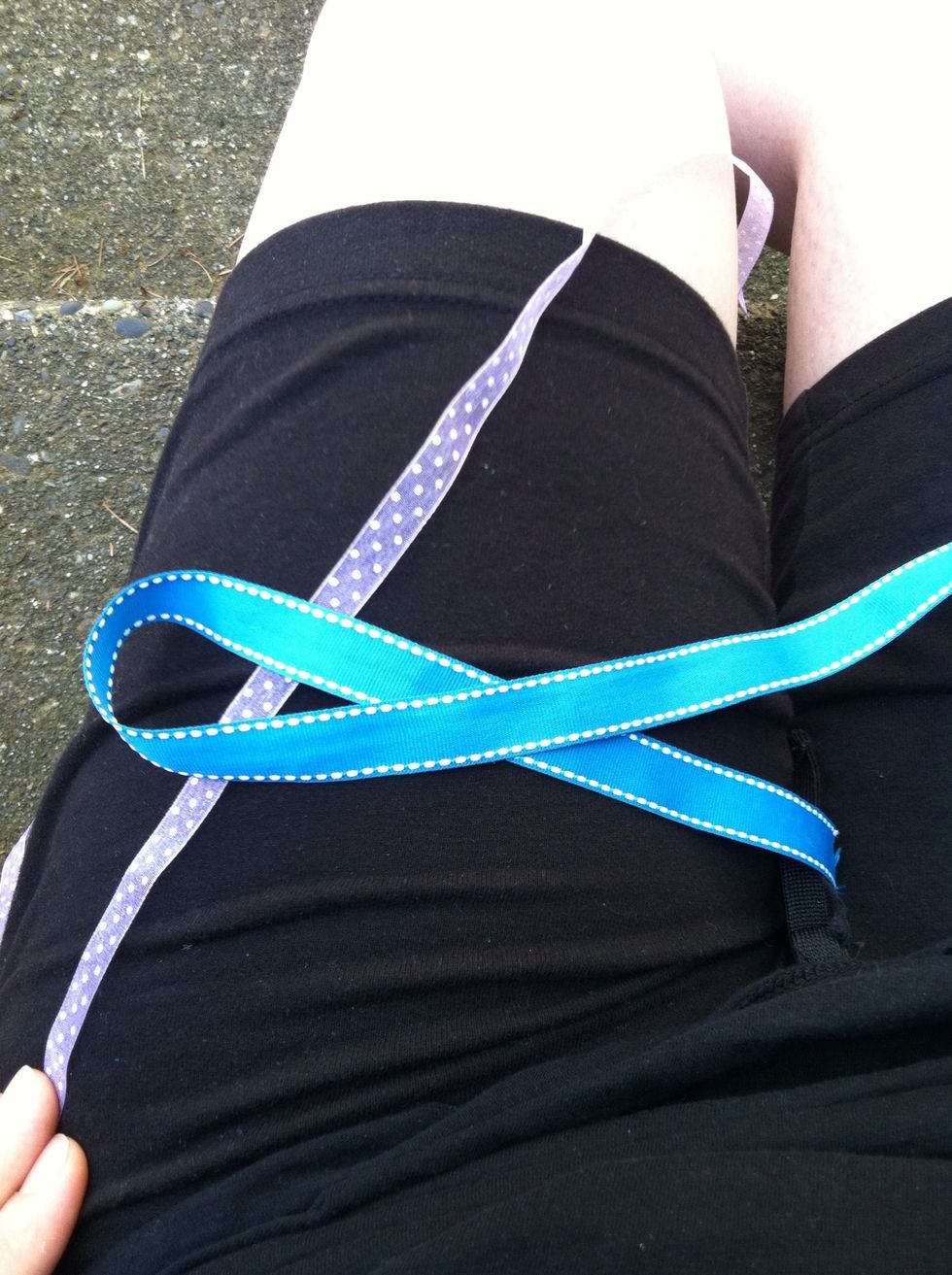 With your second piece, lay it under the loop of the first piece of rope.