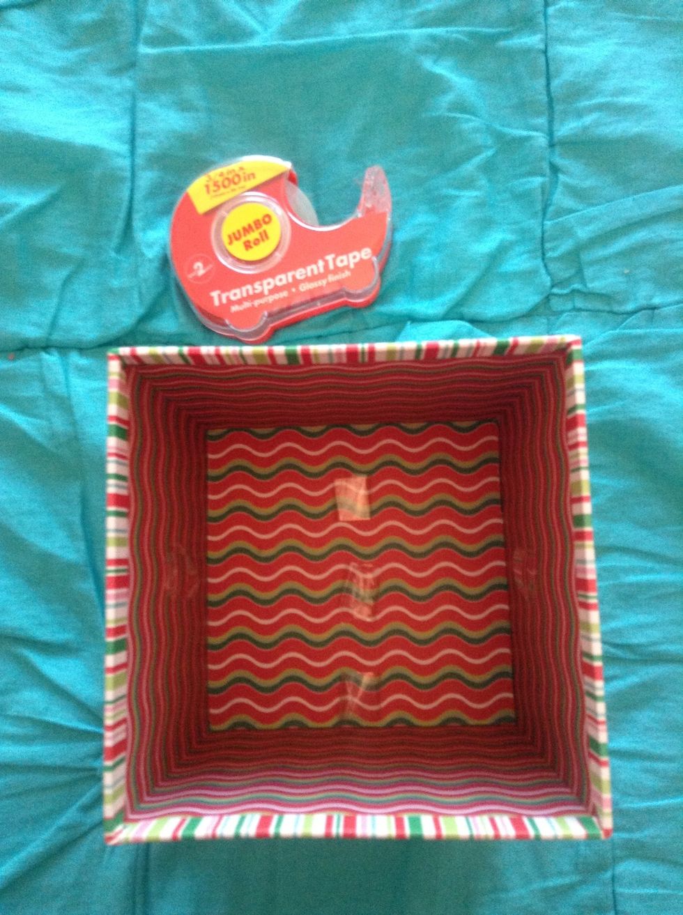 With your tape, put three pieces on the bottom of the box and two pieces of tape on the opposite side of the other tape. This will help the index cards stay up.