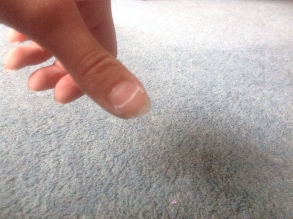 With your white nail art pen draw a basic outline of the cats head on the end of your thumb. Draw two triangles and a line. If you don't have nail art pens the end of a toothpick works just as well.