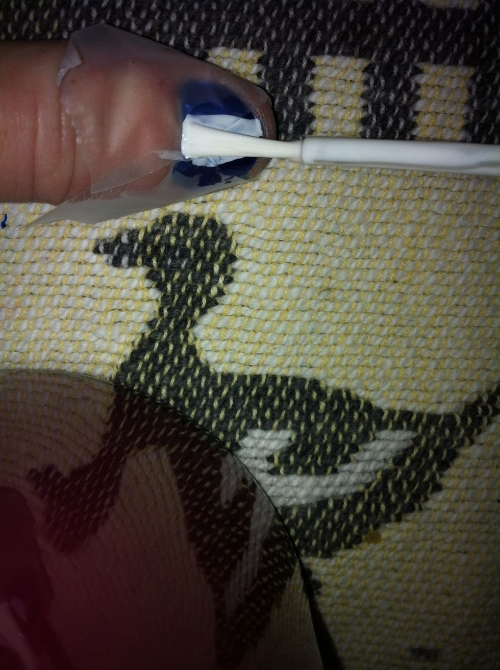 With your white nail polish paint in the triangle shape you have made with the tape