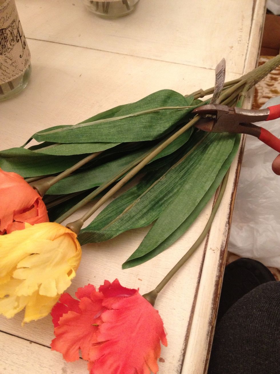 With your wire cutter, clip the stem to the right length, I'd start by doing half an inch taller than your jar, measuring from stem to stem(not including flower). You can always trim off more.