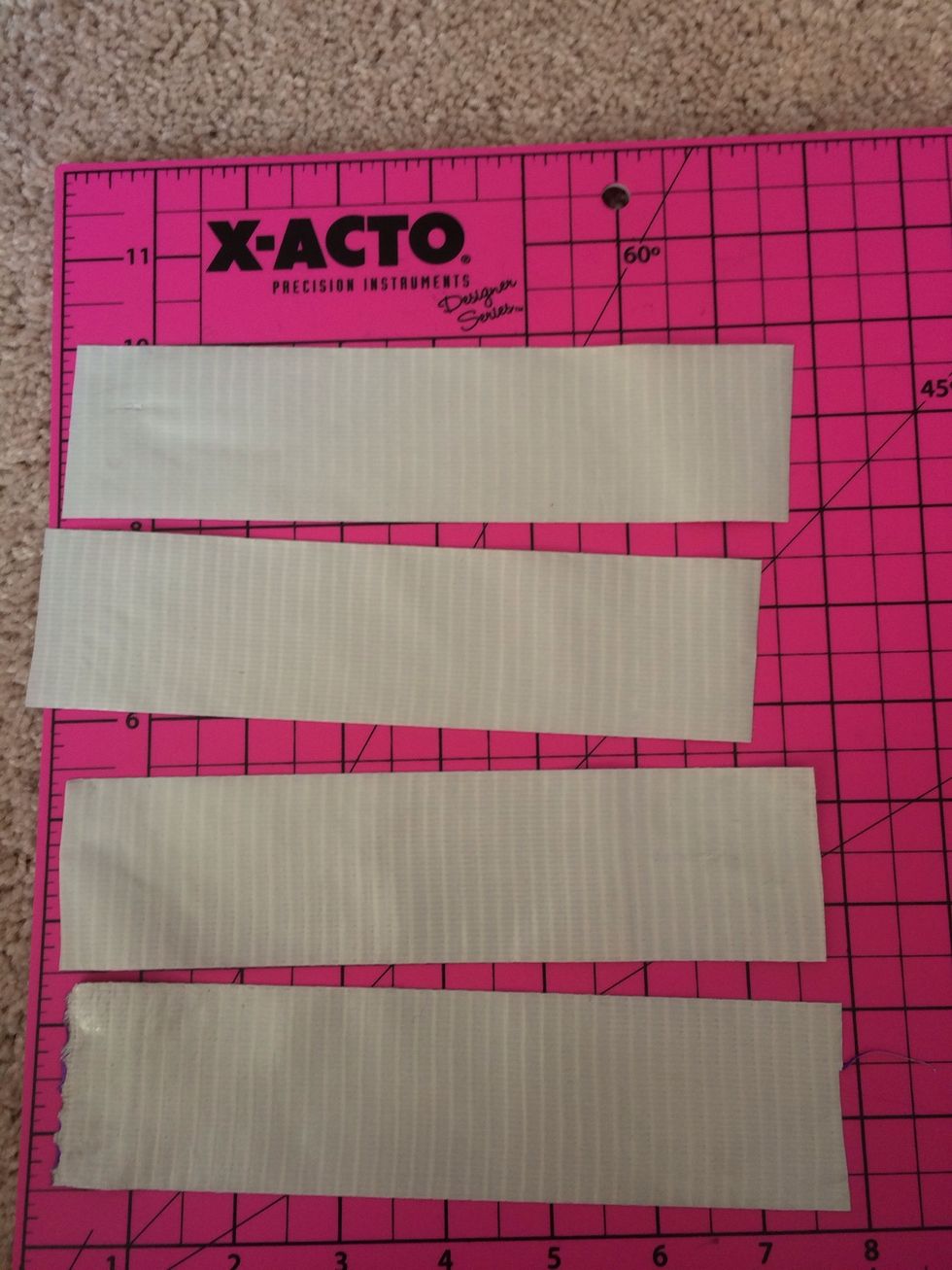 With your x-acto knife, cut four 7.5 inch pieces of colored duct tape and lay them sticky side up.