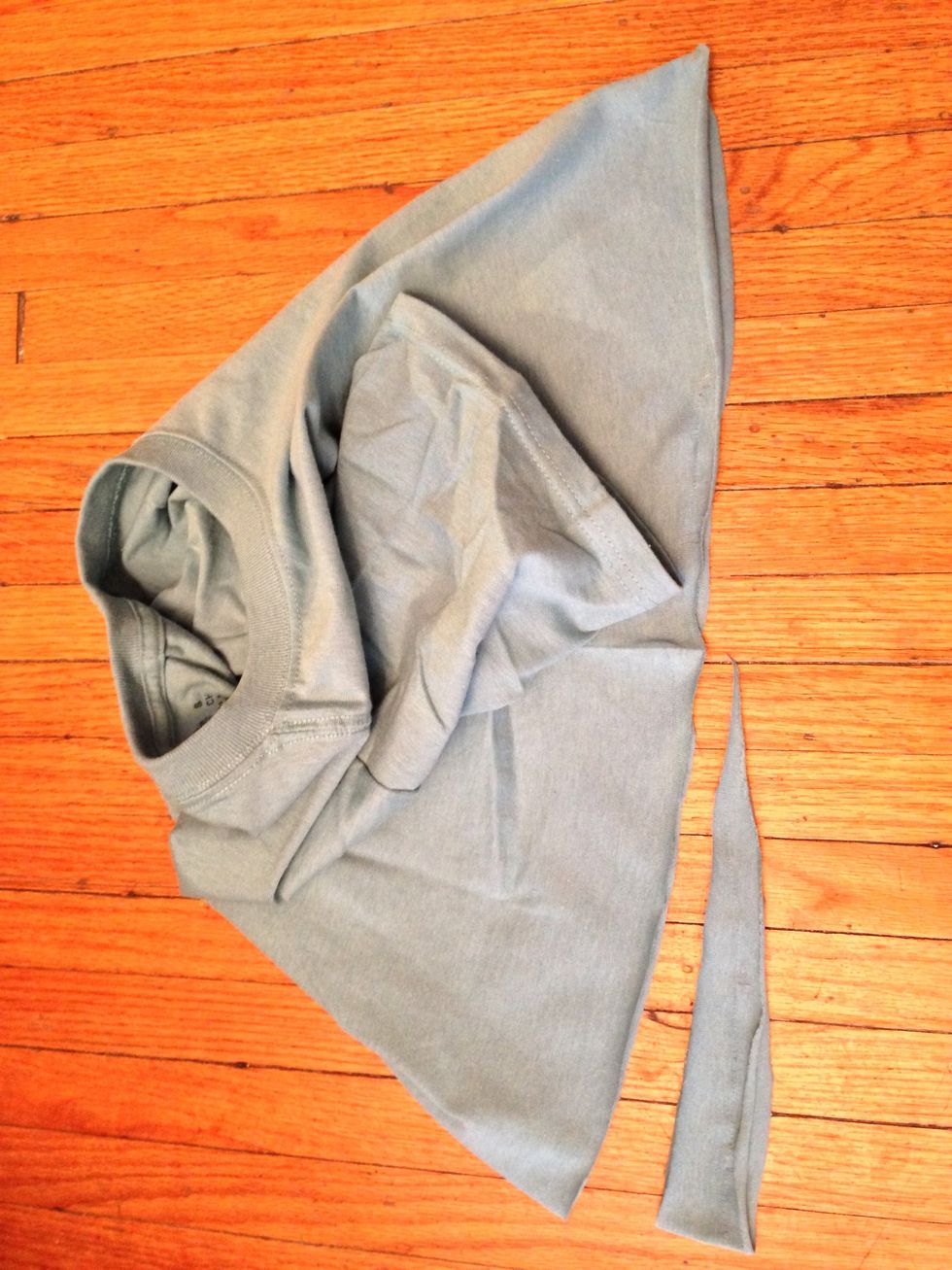 Without adjustment, the bust will cause the hem to rise in front. So, bring the sides together and trim a wedge out of the back, tapering to the sides as shown.