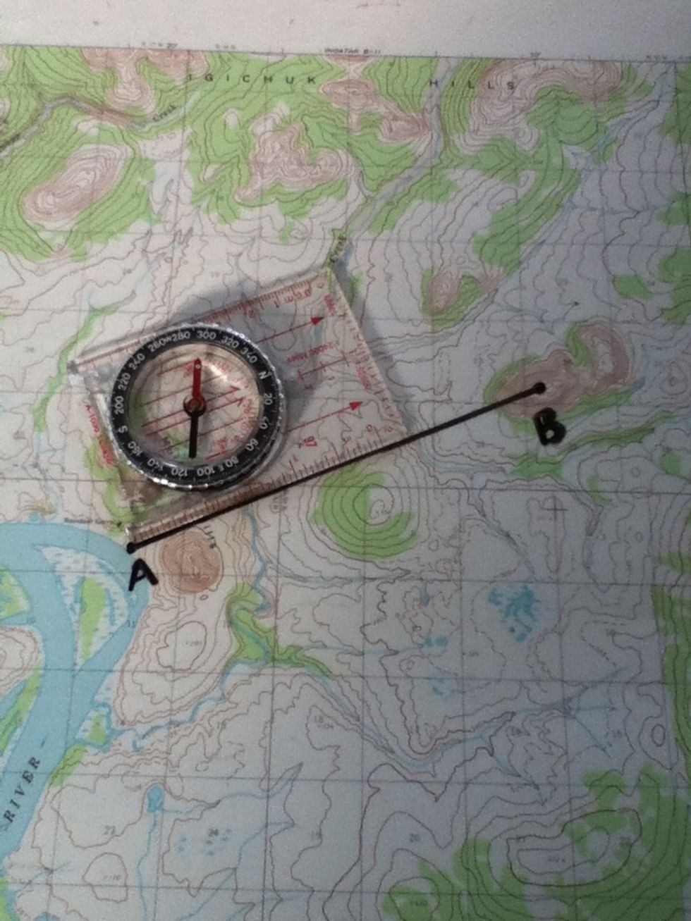 Without moving the map, align the side of the compass with the line you just drew.