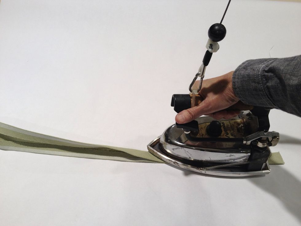 Without removing the backing from the steam-a-seam, fold the banding in half and press.