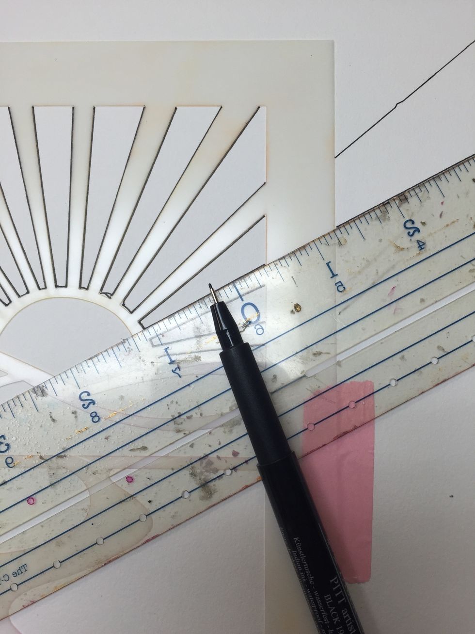 Without untaping your stencil and using a ruler extend your rays to the border of your journal page