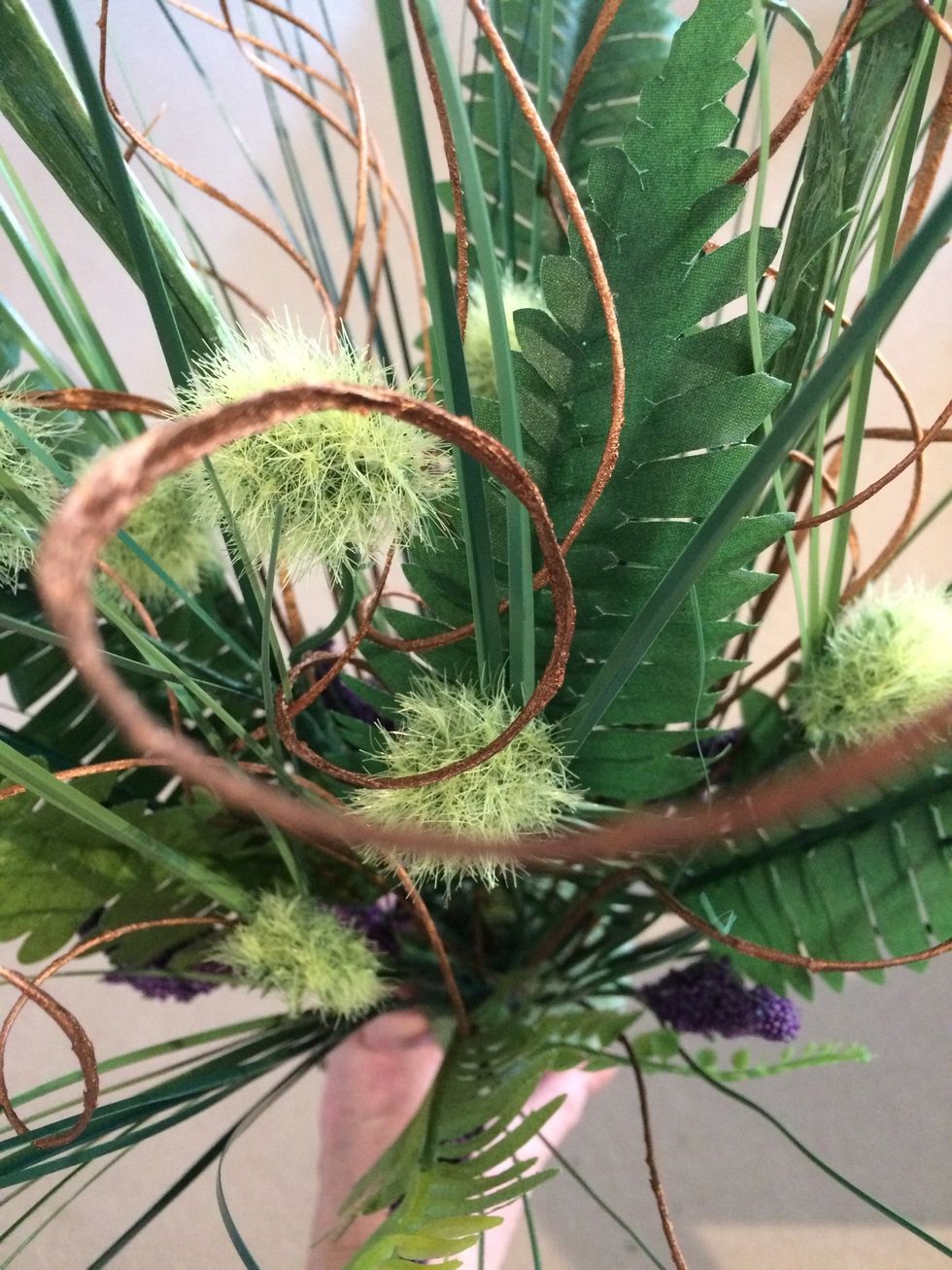 Work carefully to place the stems evenly in the arrangement. Look for space between all the other stems then poke them into the foam.