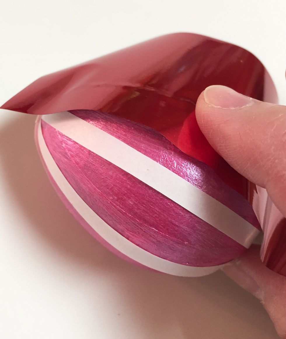 working one strip at a time, remove backing and rub with foil.