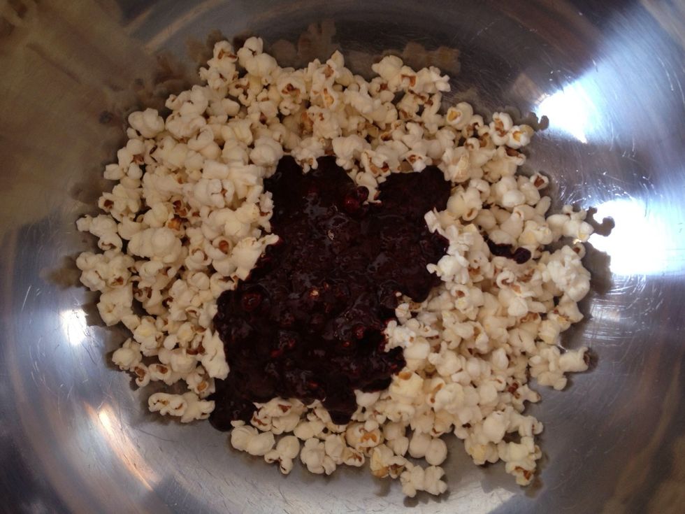 Working quickly, chuck half the caramel onto half the popcorn that you set aside earlier. Stir to combine.