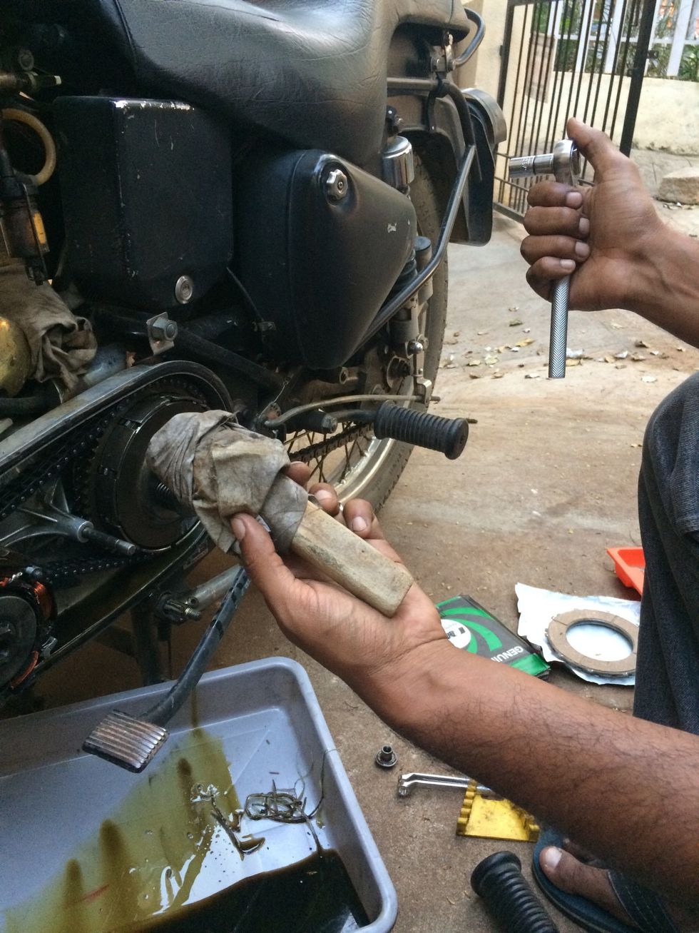 Wrap a cloth on a wooden piece and jab between the primary chain and sprocket