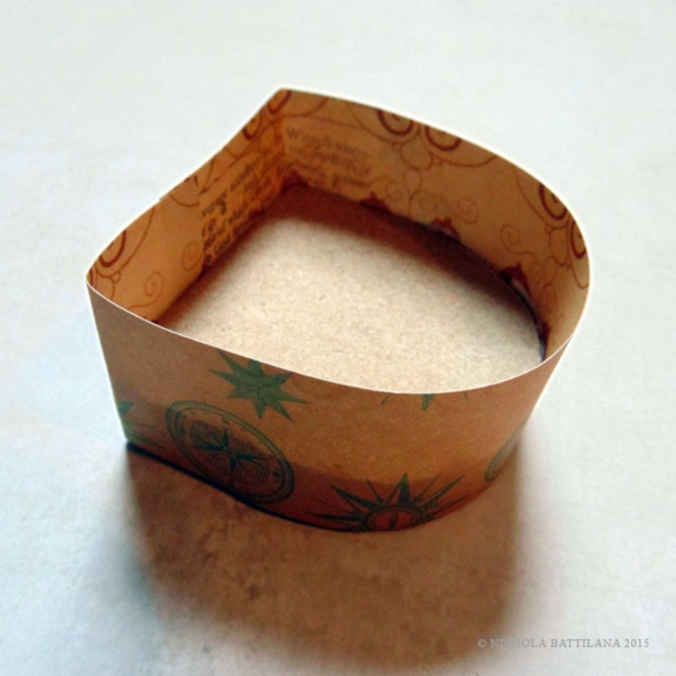 Wrap a strip of paper, taller than your box, around the sides of the box.