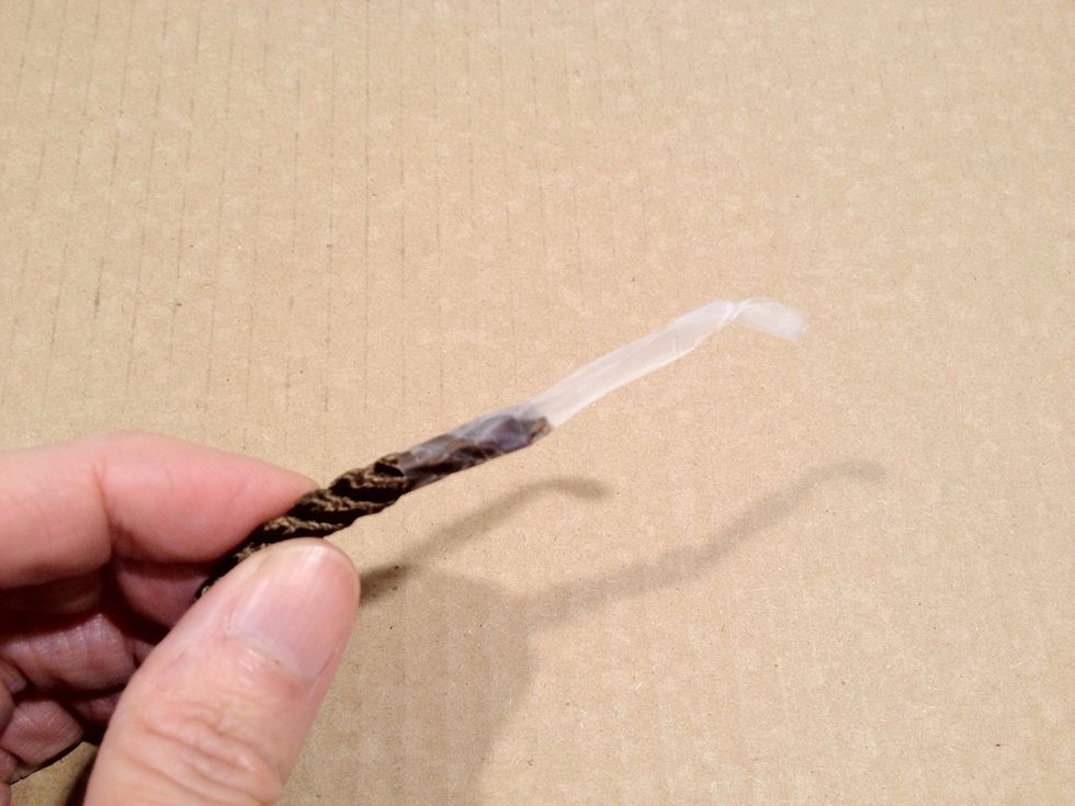Wrap additional scotch tape around one end of the decorative cord. This will enable you to thread the cord through the opening of the wooden tassel forms.
