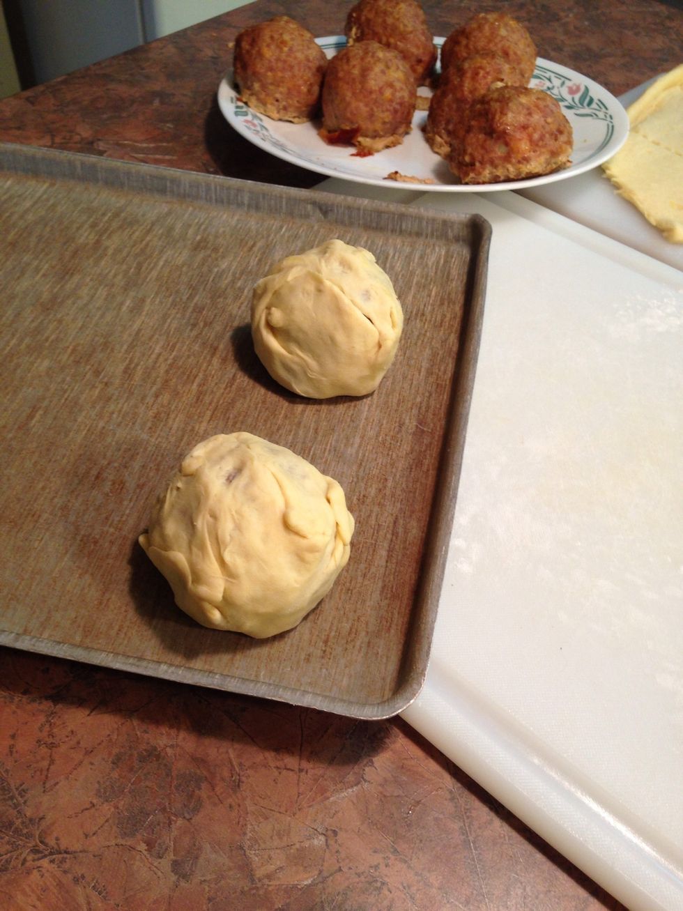 Wrap all 8 meat/egg balls as shown and place 2" apart on non-stick cookie sheet.