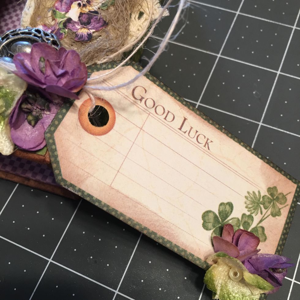 Wrap button string around the lid and tie the tag on to the lid on the right side at the bottom.