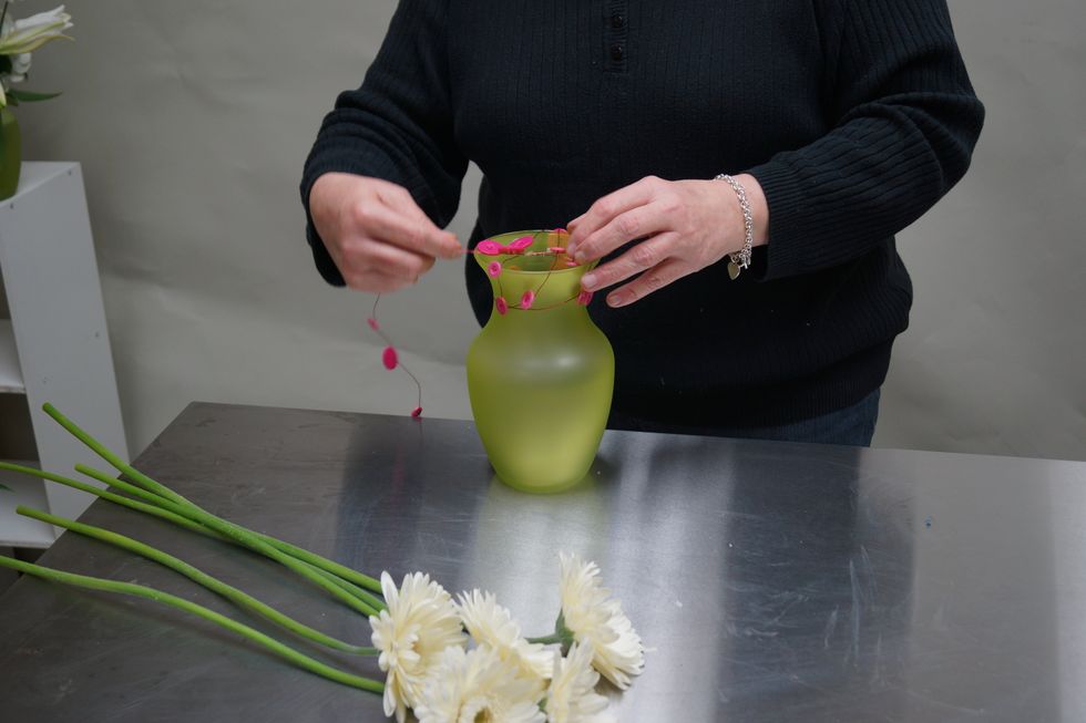 Wrap button wire around the neck of the vase and over the top.