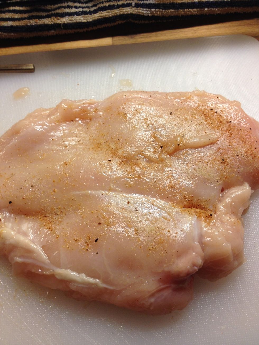 Wrap chicken breast in clingfilm and bash until 1/2 inch thick. Season with salt and black pepper. You can also add additional seasonings, I added grilled :).