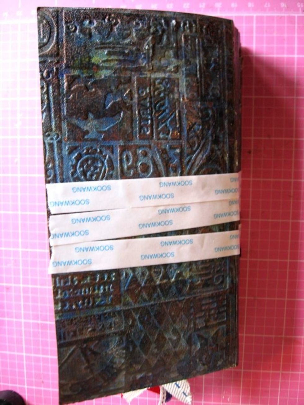 Wrap cover with 3 rows of 1/2" Scor-Tape from edge to edge.  This will hold the ribbon closure in place.