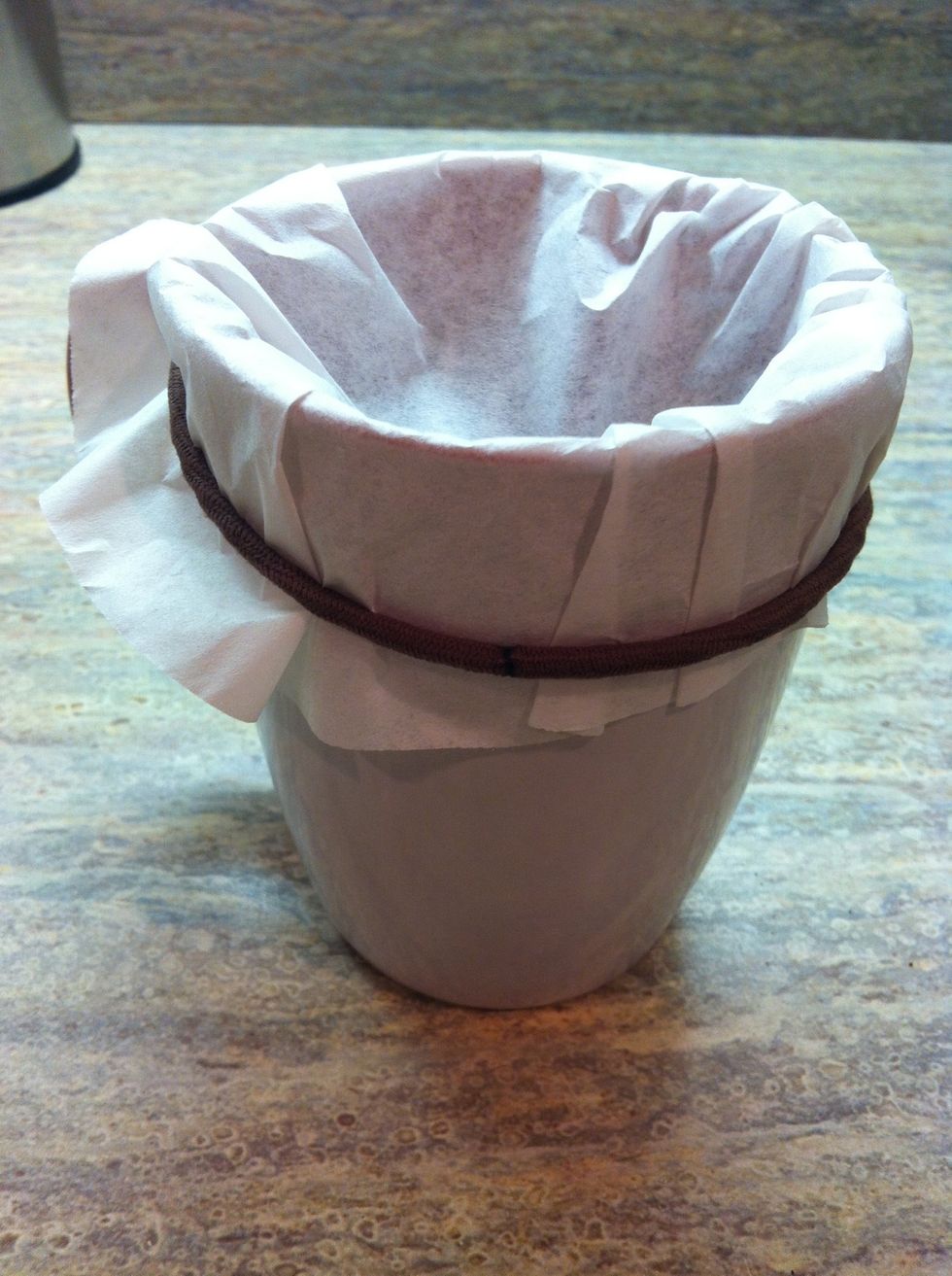 Wrap elastic band around coffee filter