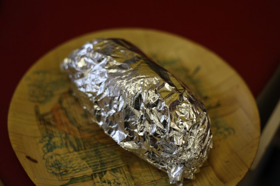Wrap in aluminium foil and place in a deep baking dish or stainless steep pan.