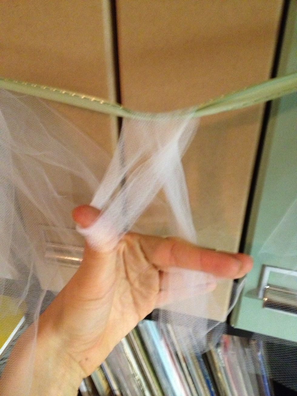 Wrap material around ribbon and pull thru loop.