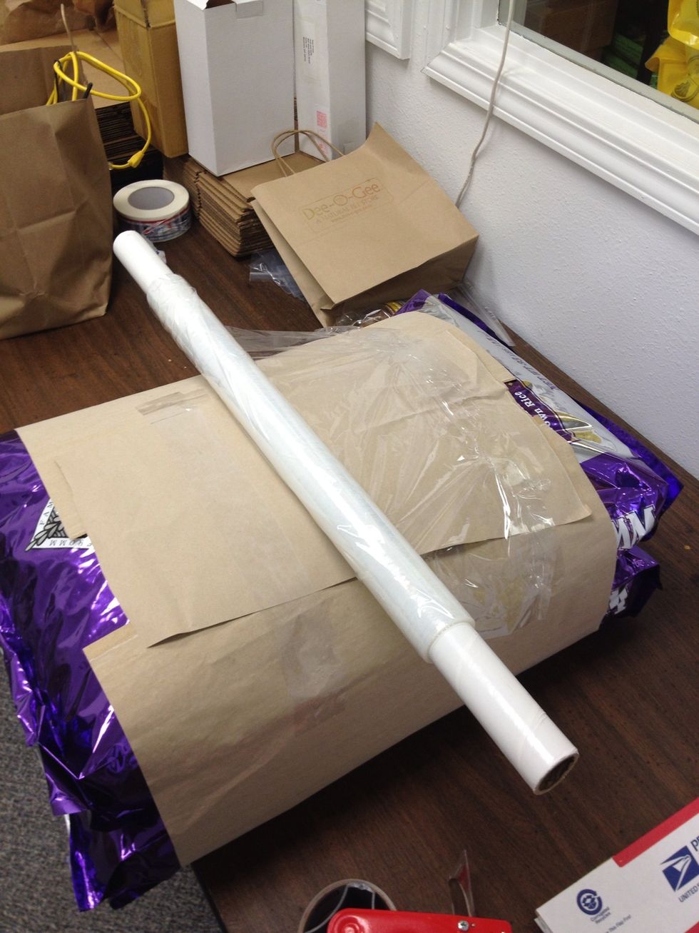 Wrap pallet slip around and tape securely. Then tape the leading edge of the cellophane across the width of the pallet slip to anchor the cellophane in place.