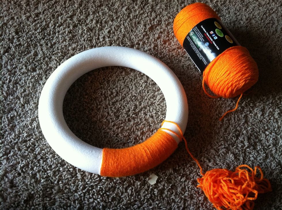 Wrap plain wreath with yarn. This step takes longer than it seems like it should! It took me two episodes of The Big Bang Theory.