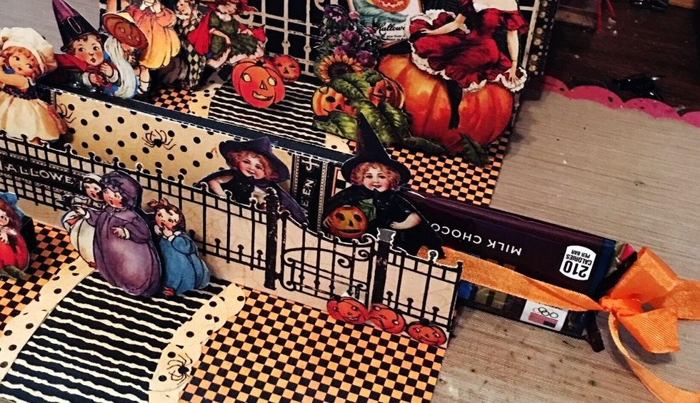 Wrap ribbon around candy bar; tie a bow. Slide into to formed candy box.