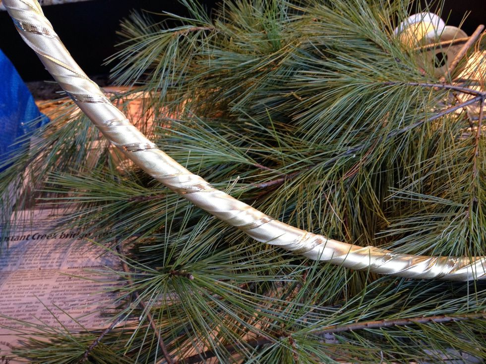 Wrap ribbon around the hula hoop to camouflage the purple plastic. I secured the ends of the ribbon with a loop of tape on the underside and a bit of wire. I don't have quite enough ribbon.