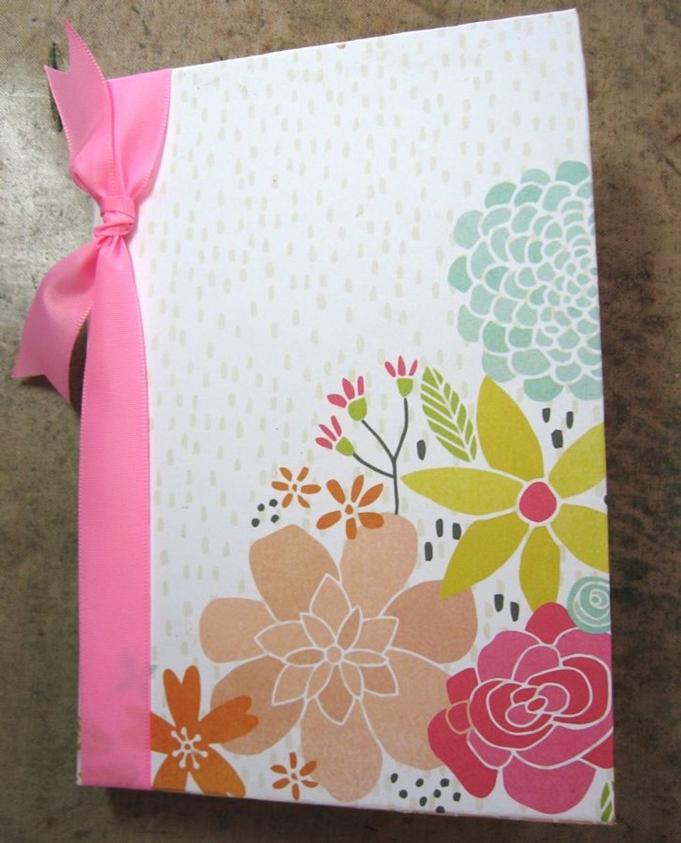 Wrap ribbon around the left hand side of the notebook and tie with a simple square knot. Now we are ready to decorate the inside of the notebook.