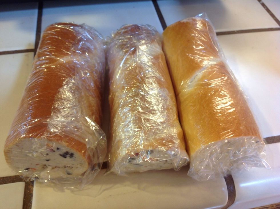 Wrap stuffed baguette rolls tightly in cellophane wrap. Keep in refrigerator at least two hours, and up to two days. (This is a good appetizer to make ahead for a party)