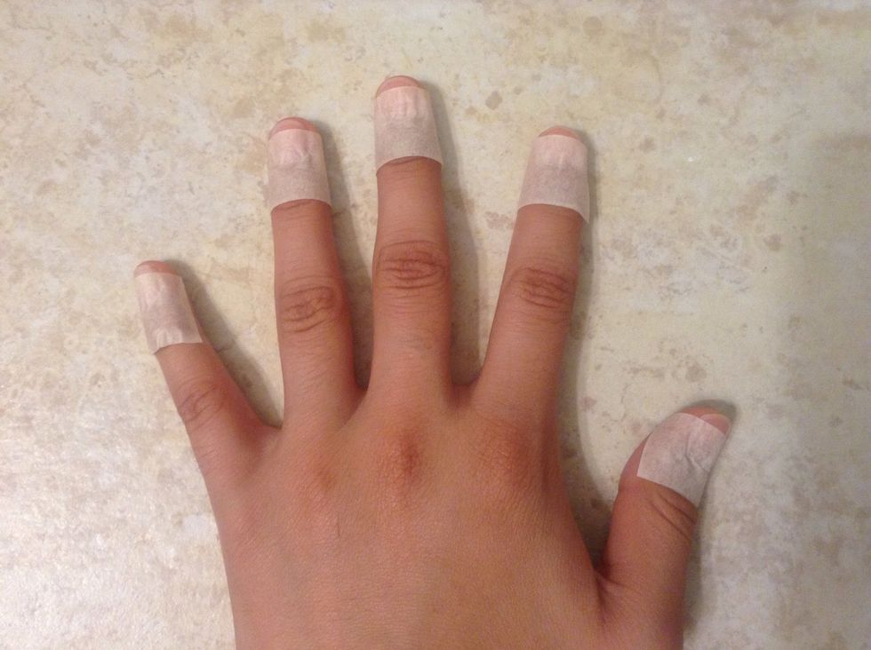 Wrap tape around your nails leaving a small amount on the tip