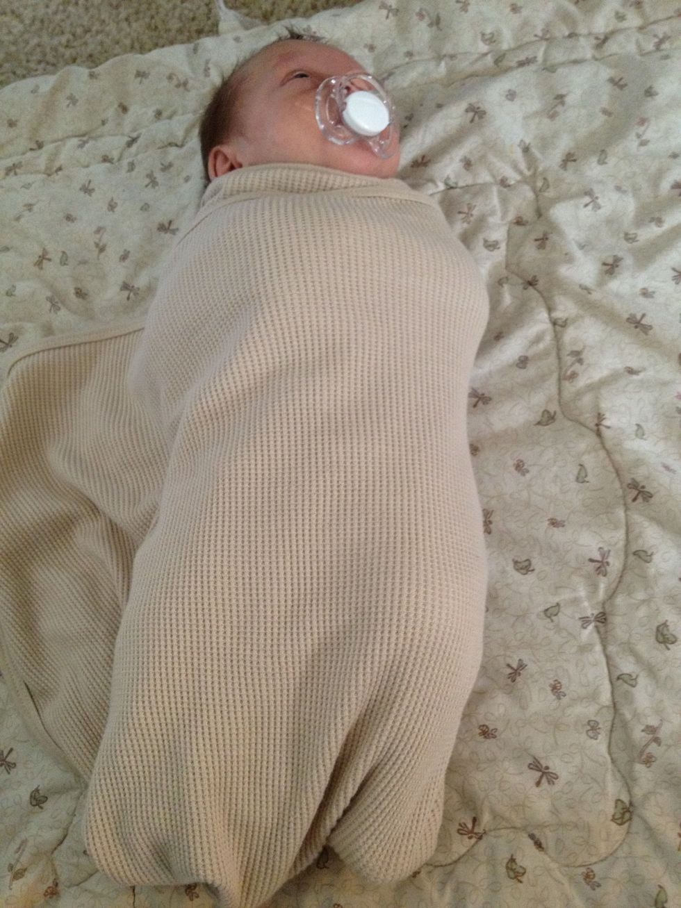 Wrap the bottom half right side of blanket under the baby.