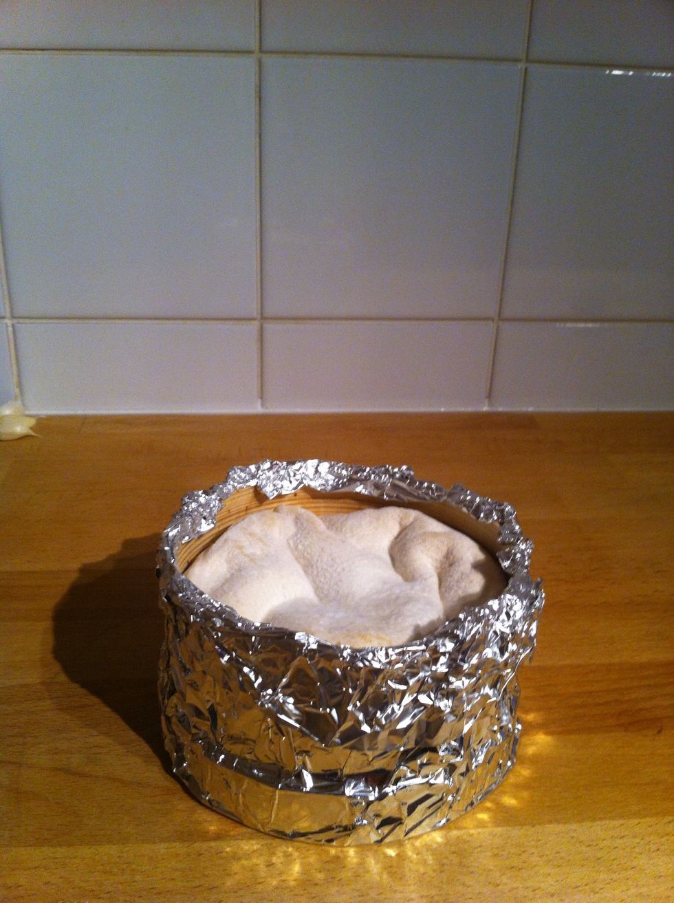 Wrap the box Mont d'Or with foil, with this you will avoid burning the wood while baking
