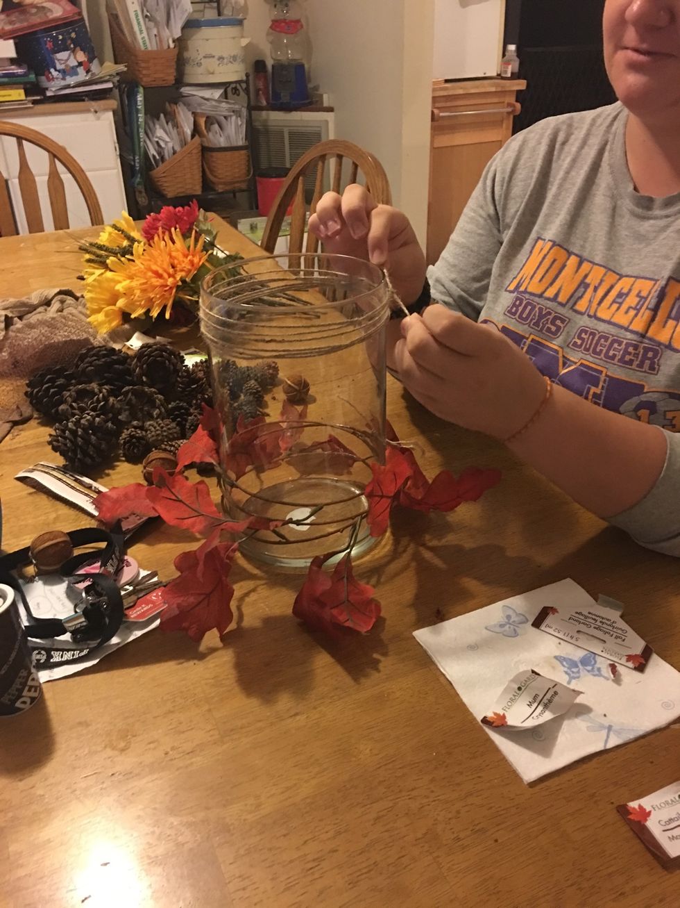 Wrap the cord around the top of the vase and tie it securely.