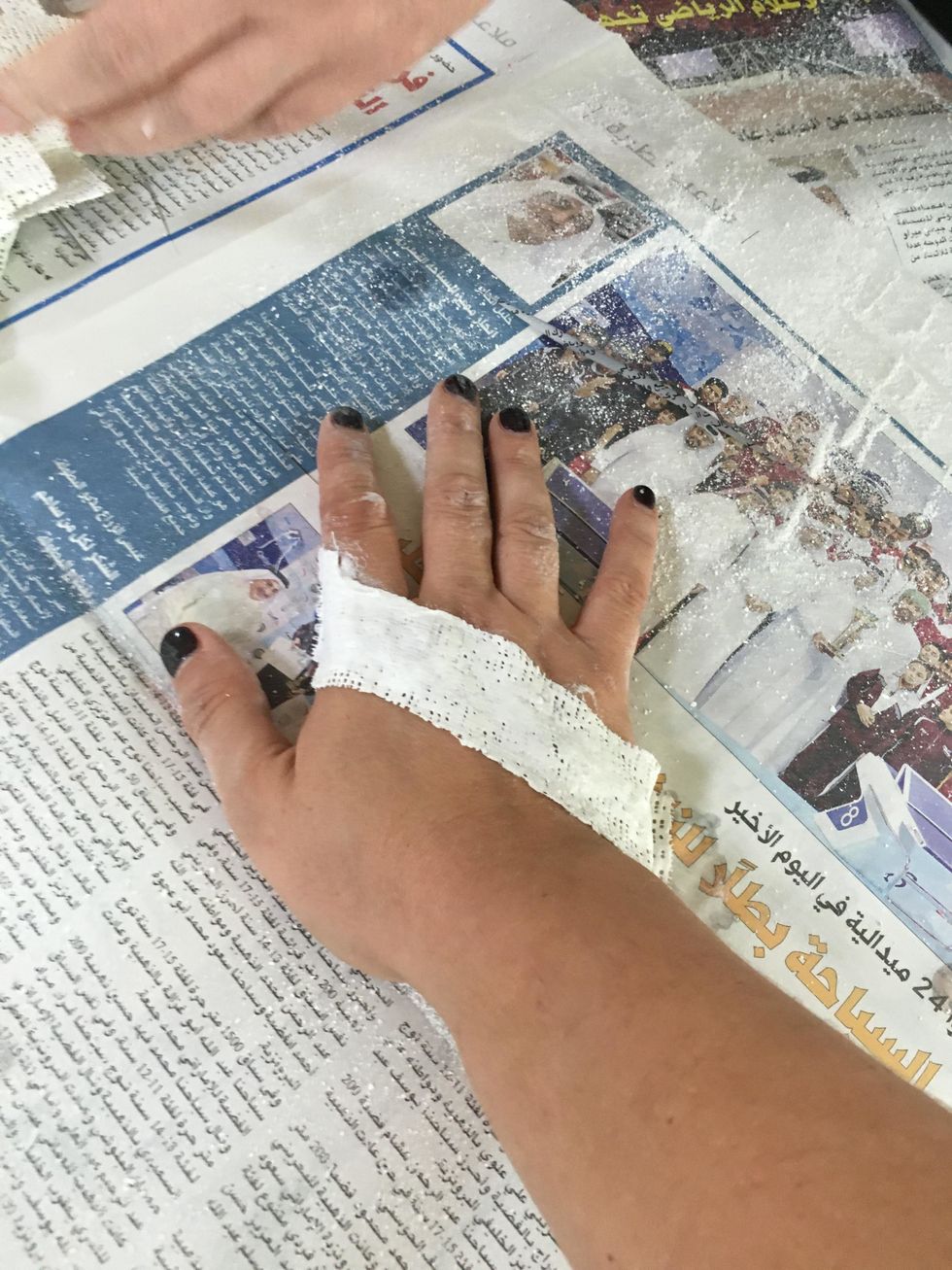 Wrap the damp plaster strip over the hand and gently rub in plaster to smooth out the strip. You will smooth out the tiny holes in the strip.