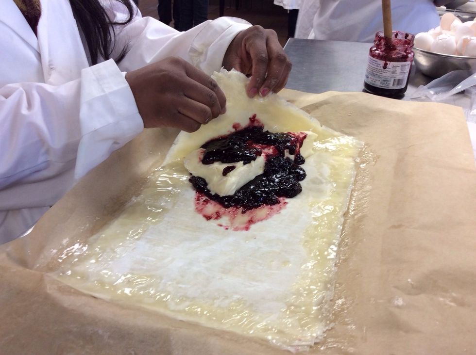 Wrap the dough around the cheese in a triangular shape