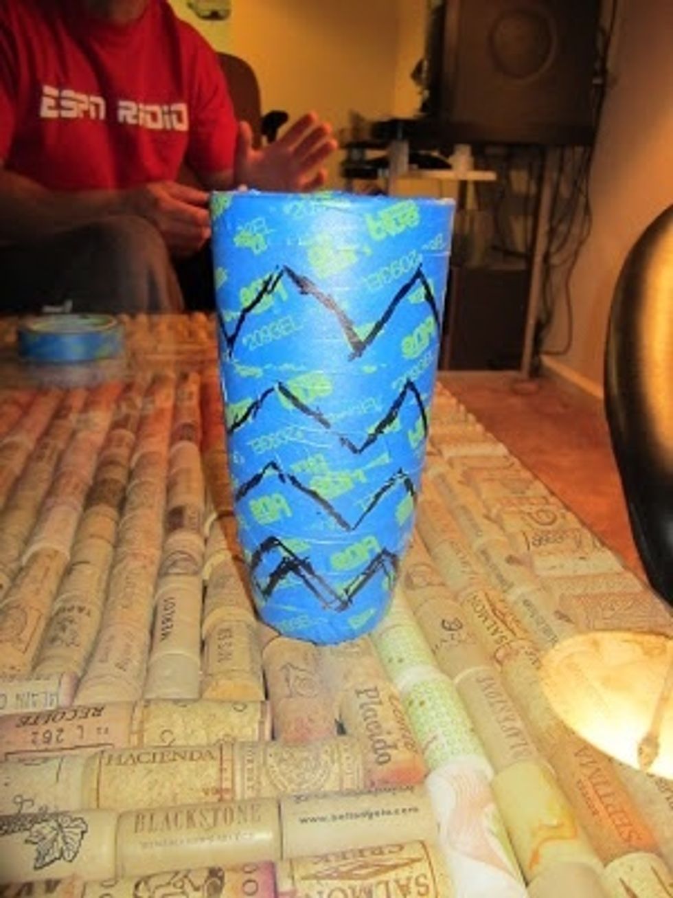 Wrap the entire glass in the painters tape. Be sure to get out any air bubbles using a credit card and hard edge. The draw your pattern.